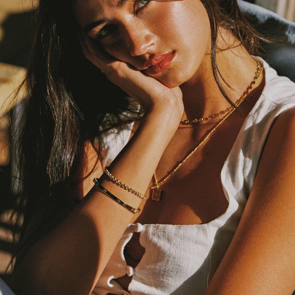 Brazalete Estelar ZAYA rígido con grabados de estrellas y circonias, baño de oro 18K; hipoalergénico, a prueba de agua y con garantía de por vida.